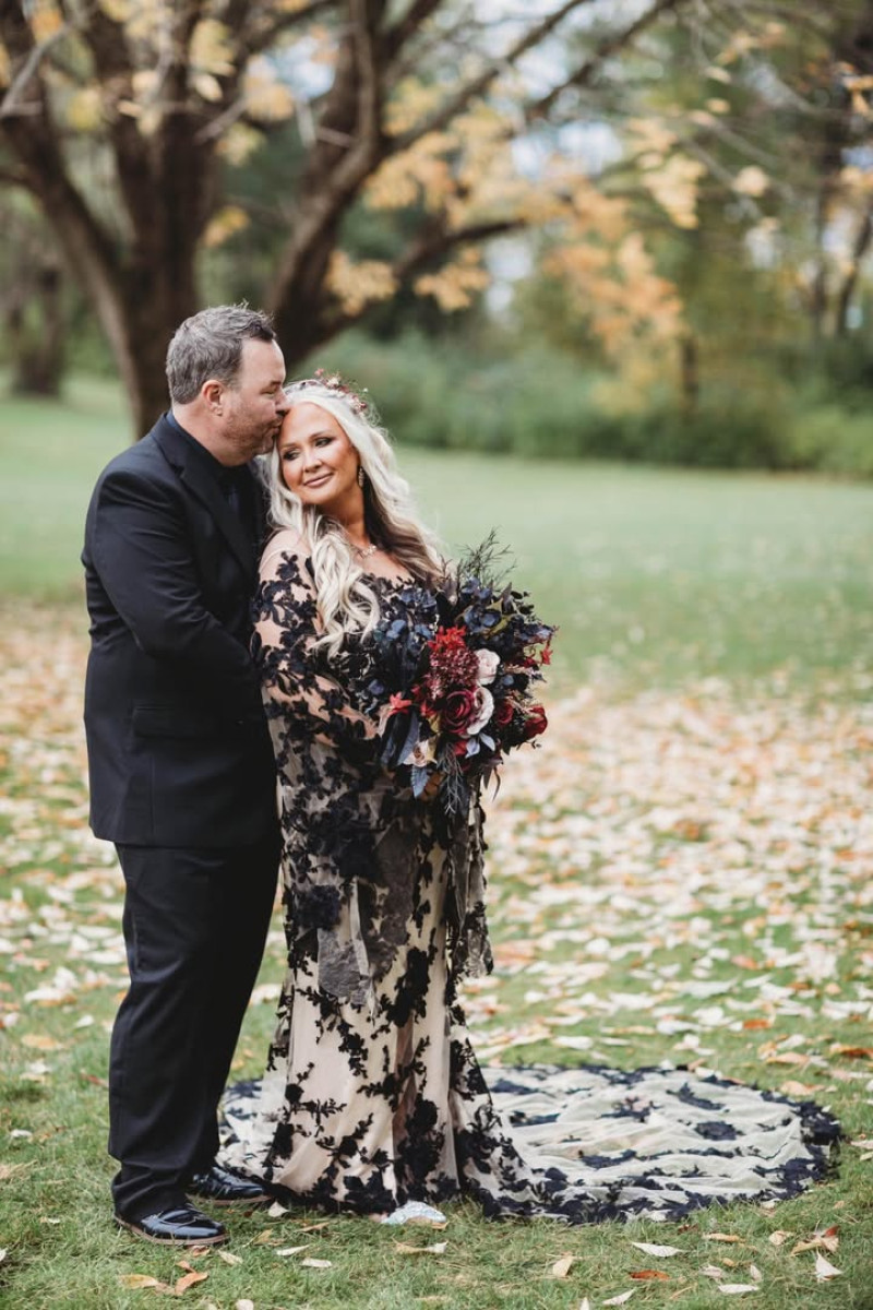 Dramatic wedding bouquet with deep burgundy roses, beige accents, and golden details