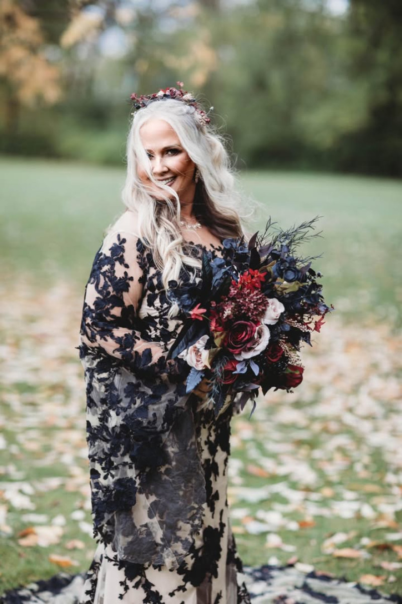 Elegant faux bouquet in black and burgundy with beige blooms and gold foliage