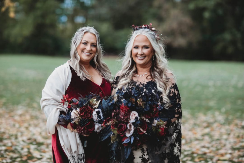 Artificial bridal bouquet in rich burgundy, soft beige, matte black, and metallic gold