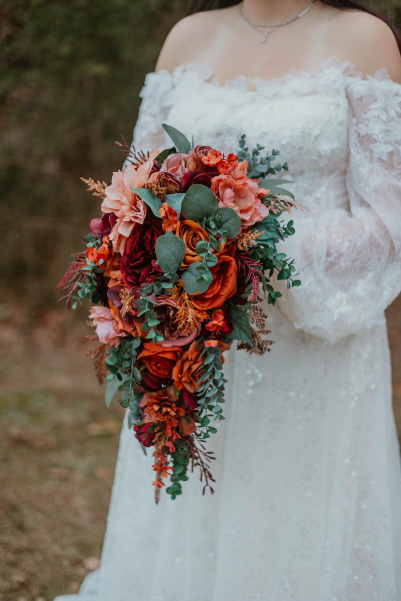 Boho-inspired wedding bouquet in warm burgundy, dusty rose, and rust tones