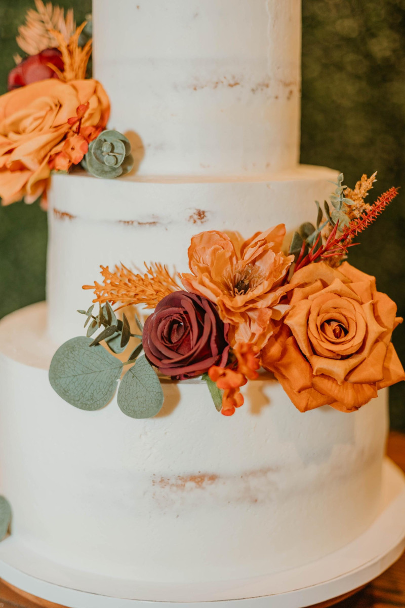 Cake flowers in burgundy, dusty rose, terracotta, and rust for boho wedding cake decoration
