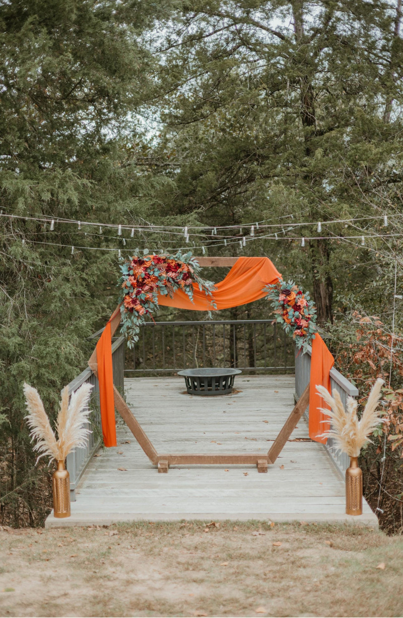 Wedding arch arrangement with burgundy, dusty rose, terracotta, and rust artificial flowers