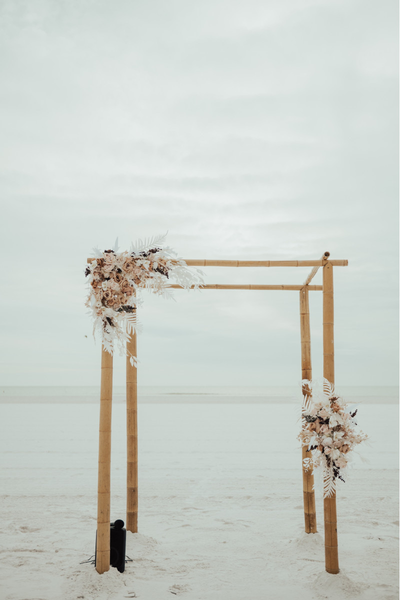Boho flower arch arrangement in beige, white, and brown with pampas and neutral blooms