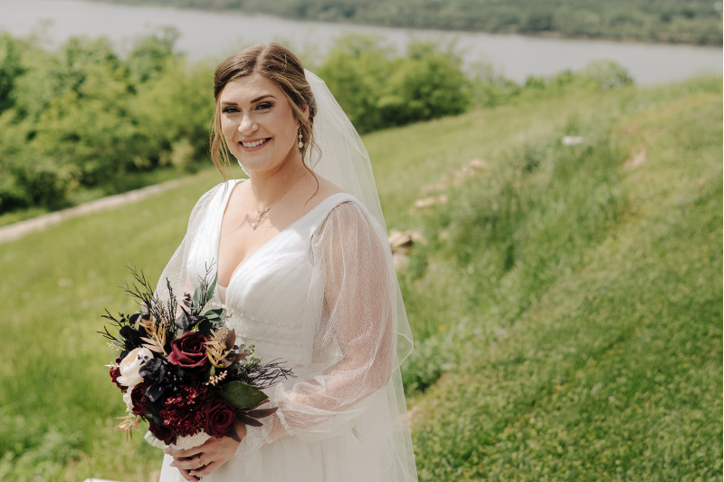 Wedding  flowers in burgundy, black, gold, and ivory with silk blooms