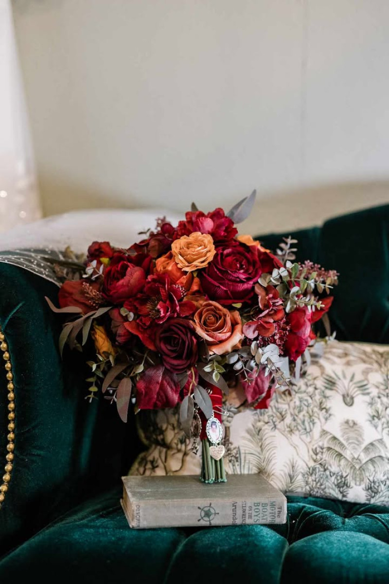 Rust, Burgundy & Cinnamon wedding bouquet on emerald velvet chair, moody autumn wedding styling720-1200