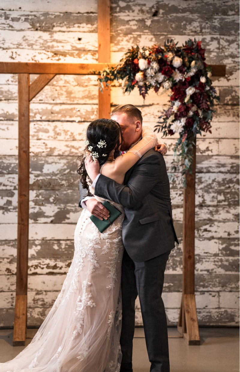 Faux wedding arch flowers in burgundy and ivory with silk roses and elegant greenery