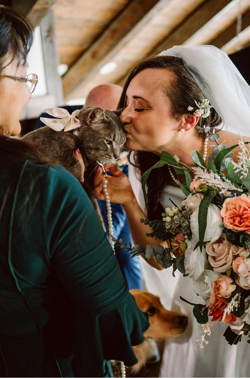 Bride with peach and blush pink  wedding bouquet with greenery