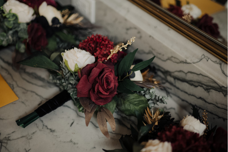 Bridesmaid bouquet in burgundy and ivory with gold accents and black roses