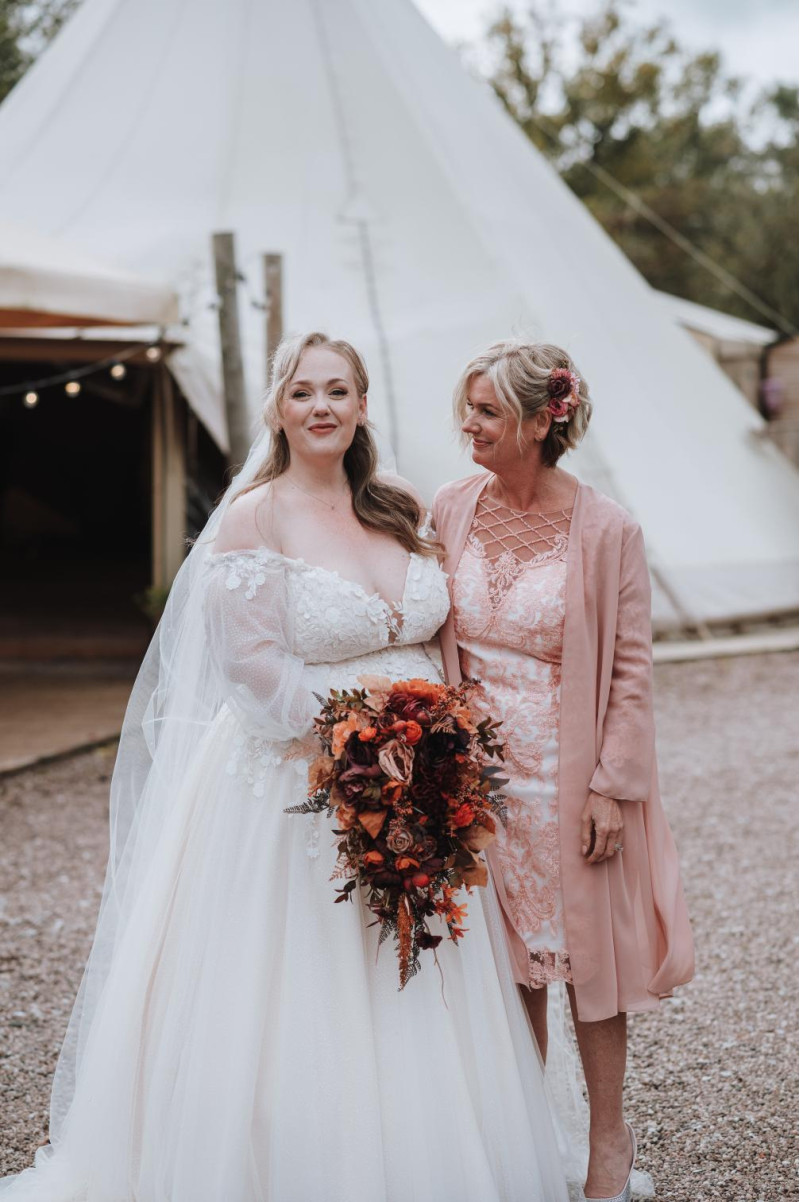 bride and mother with plum, purple, orange, rust and beige wedding bouquet