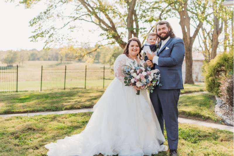 Dusty mauve and dusty blue wedding bouquet with soft white flowers for a romantic family wedding portrait