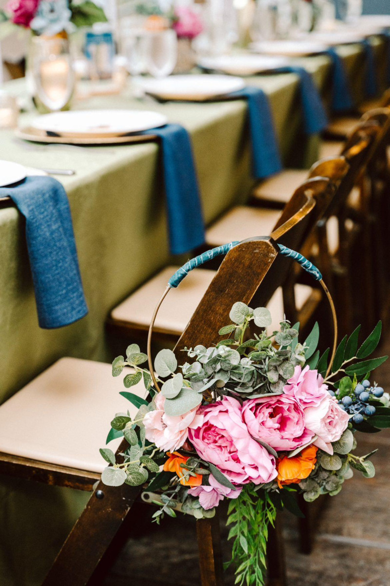 Floral ring in emerald green, magenta, teal, and orange with delicate jewel-tone blooms