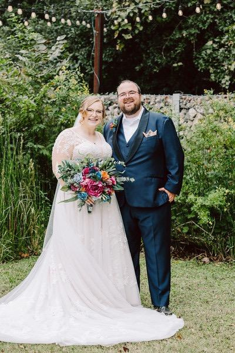 Jewel-tone bridal bouquet with emerald green, magenta, teal, and orange silk flowers