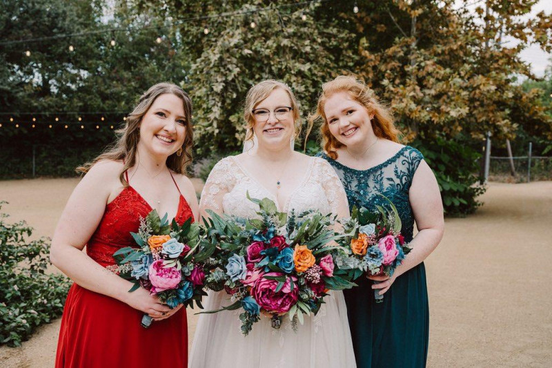 Bold wedding bouquet in emerald, orange, magenta, and teal with vibrant faux blooms1024-533.59375