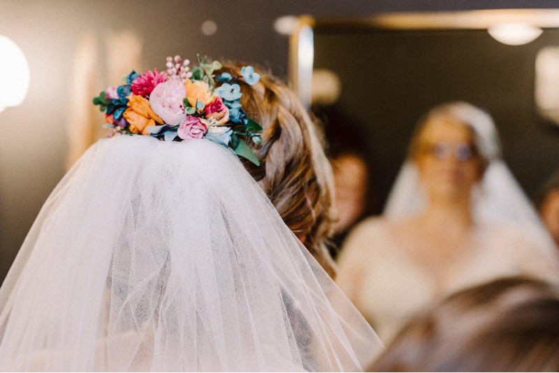 Hair comb with artificial flowers in magenta, teal, orange, and emerald for a jewel-tone wedding