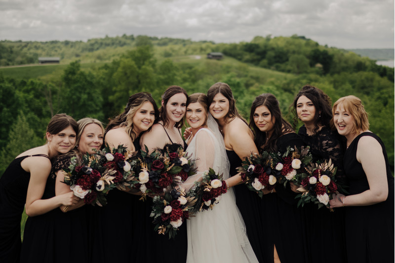 Burgundy and ivory bridal bouquet with black flowers and gold touches