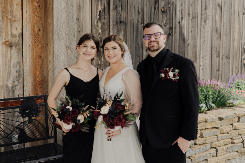 Gold and black wedding florals with burgundy roses