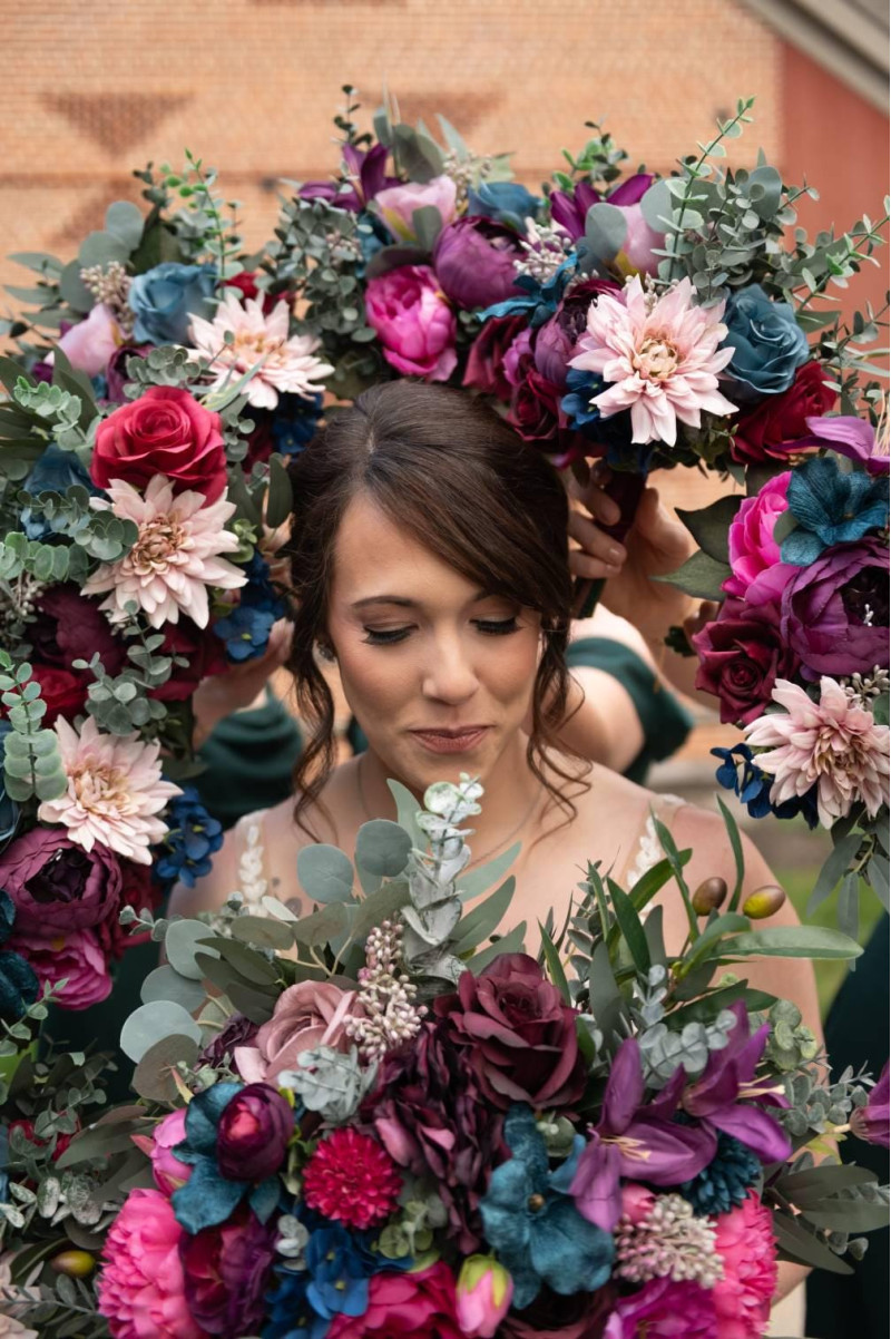 Jewel tone wedding collection, bride surrounded by bridesmaids bouquets in magenta, plum, teal, blush and greenery