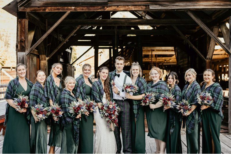 Burgundy navy blue and gold wedding bouquets with bride groom and bridesmaids in green dresses