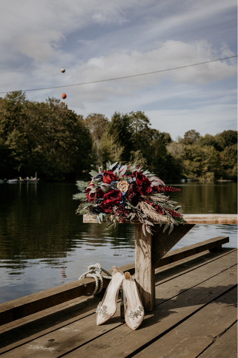 Burgundy navy blue and gold cascading wedding bouquet with roses greenery and dried accents