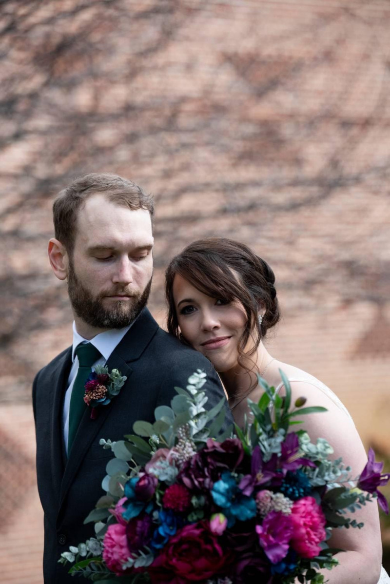 Jewel tone wedding collection, bride and groom close portrait with burgundy, plum and teal bouquet and boutonniere1004-1198.406374502