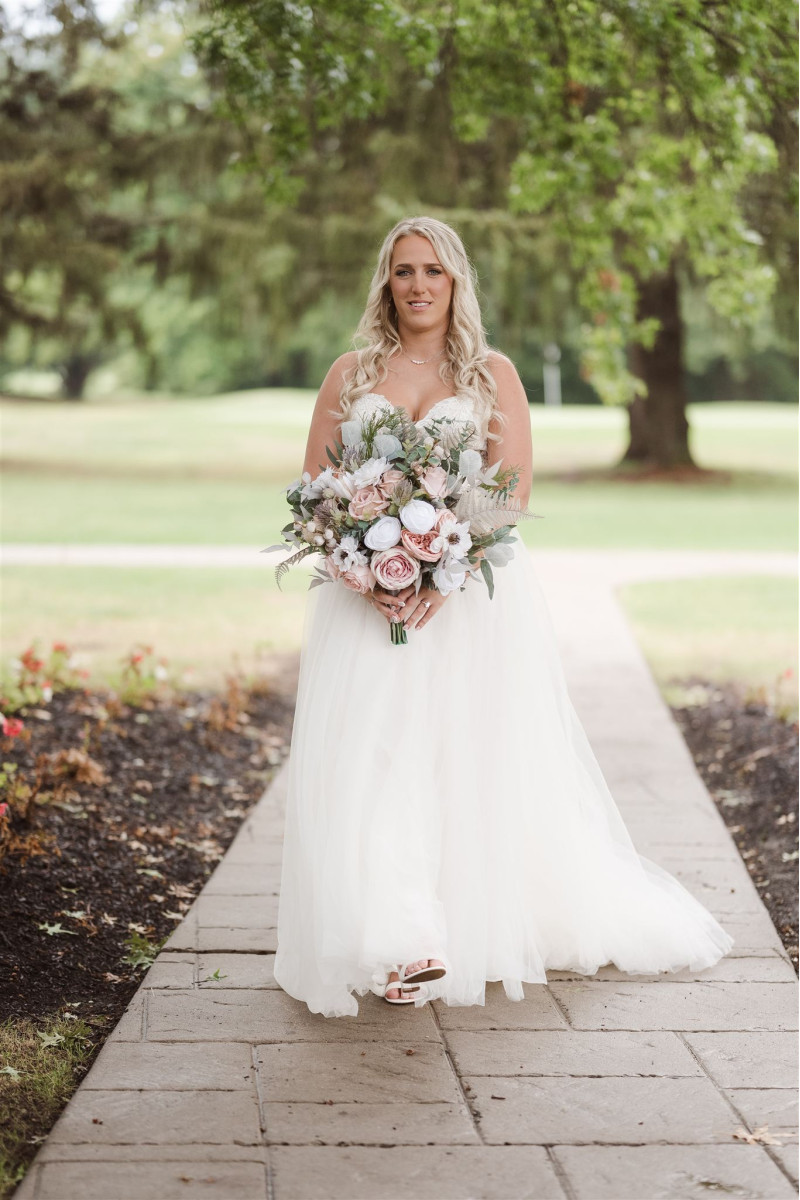Blush pink and beige wedding bouquet with white blooms and airy greenery accents