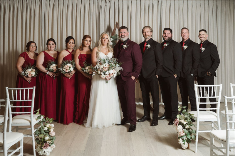 Bridal party wedding flowers in blush pink, white, and beige with bridesmaid bouquets and groomsmen boutonnieres