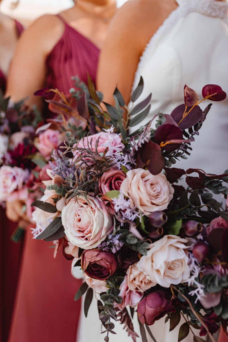 Mauve purple and beige wedding bouquets with roses and soft foliage