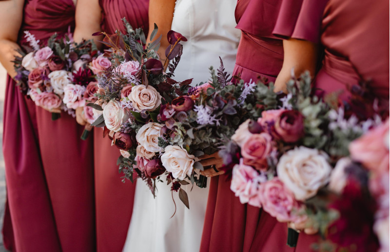 Mauve purple and beige bridesmaid bouquets with roses and eucalyptus