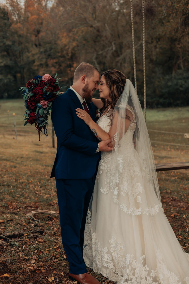 Bride and groom with burgundy pink wedding bouquet and boutonniere