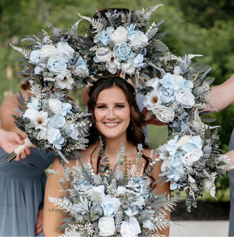 Wedding bouquets in dusty blue and white with soft silk flowers for a romantic bridal look