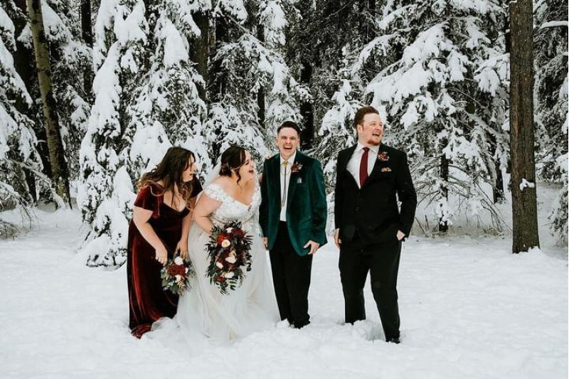 Winter wedding party with burgundy and black floral bouquets