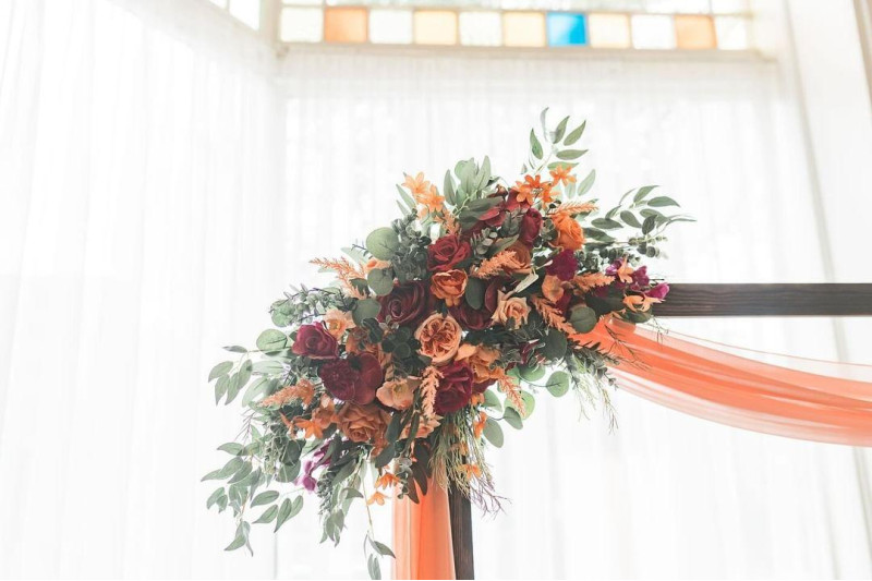 Magenta peach and coral faux floral wedding arch flowers with eucalyptus greenery