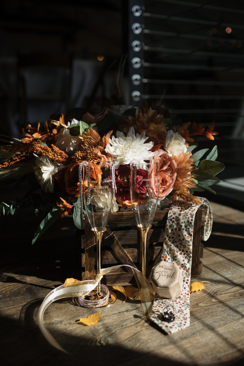 Rustic boho bouquet with pampas, orange dahlias, and burgundy roses