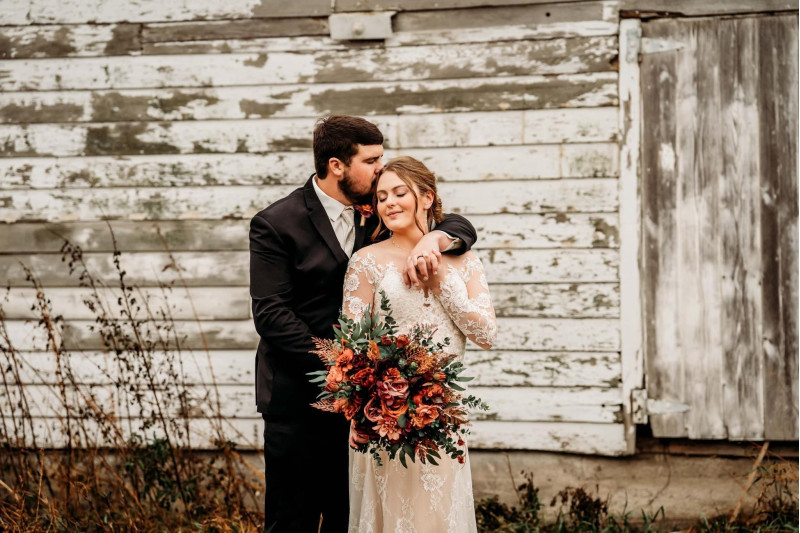 Artificial bridal bouquet in burgundy, dusty rose, terracotta, and rust with silk flowers