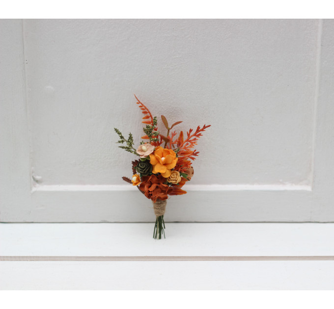 Wedding boutonniere in terracotta, rust and orange colors