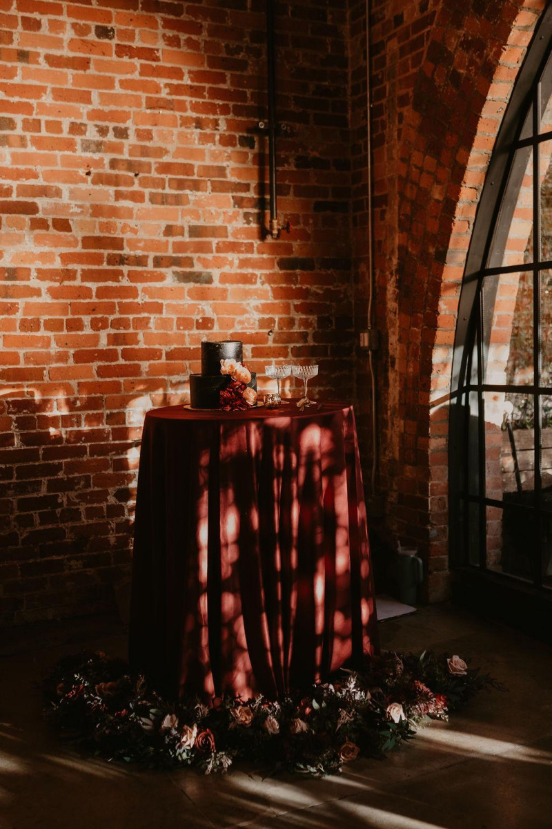 Bridesmaid bouquet with artificial blooms in burgundy, beige, purple, and black1024-1200