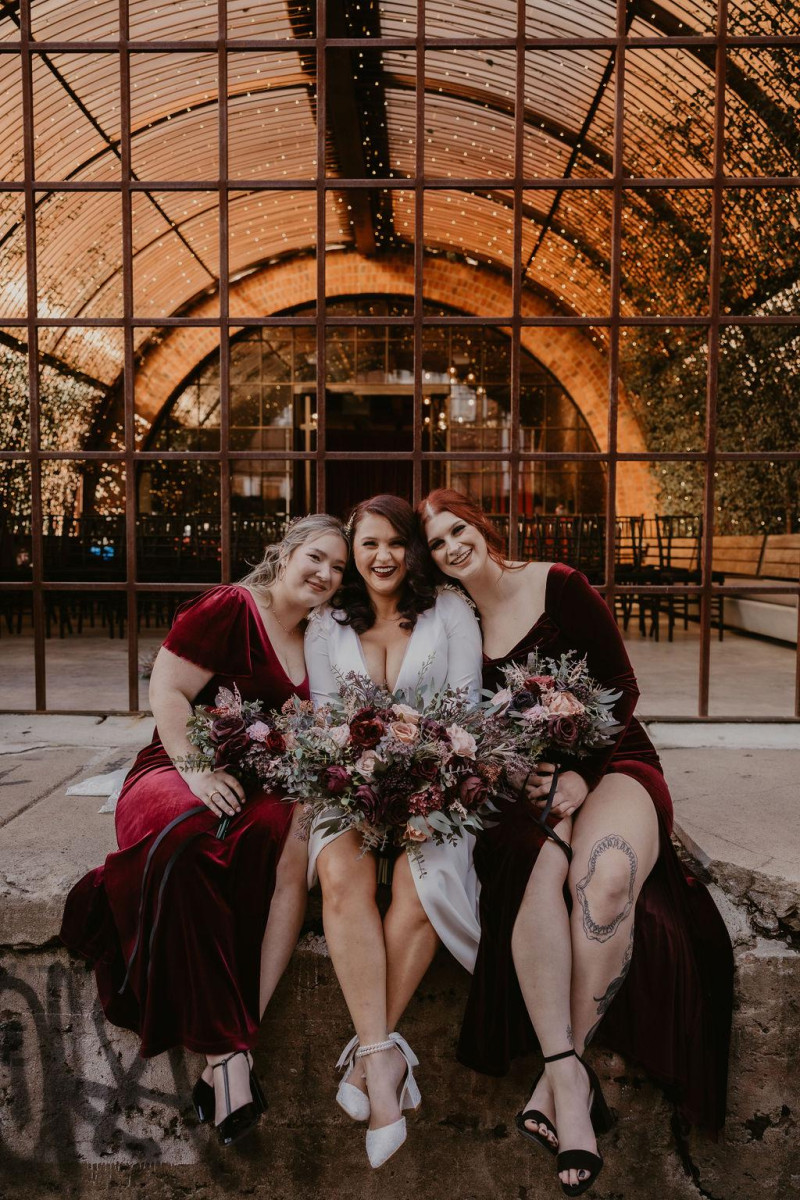 Artificial bridal bouquet in burgundy, beige, purple, and black with silk flowers
