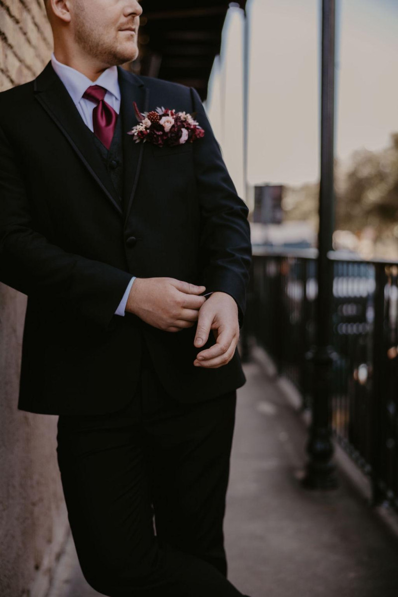 Pocket boutonniere in burgundy, beige, purple, and black with modern floral design