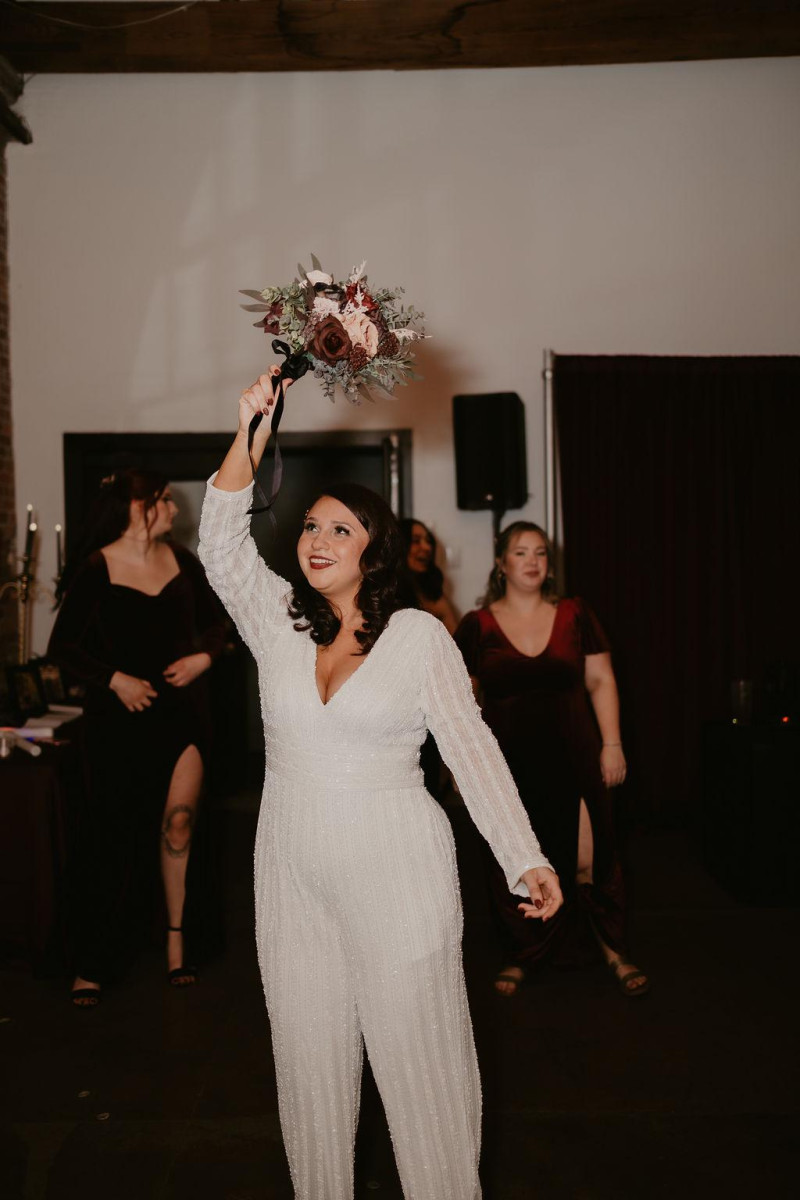 Faux wedding bouquet with burgundy, beige, purple, and black floral arrangement