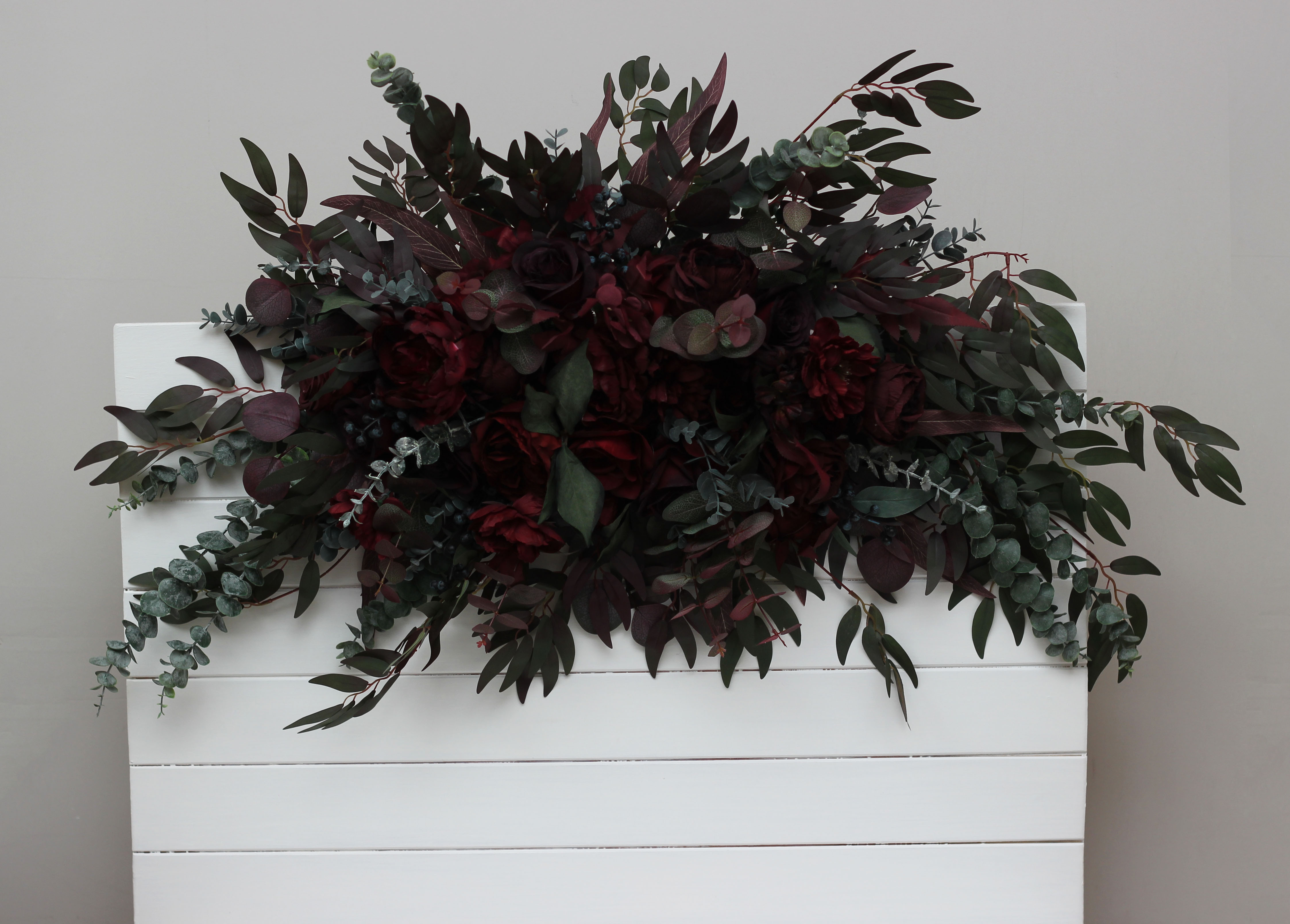 Moody dark burgundy arch flowers