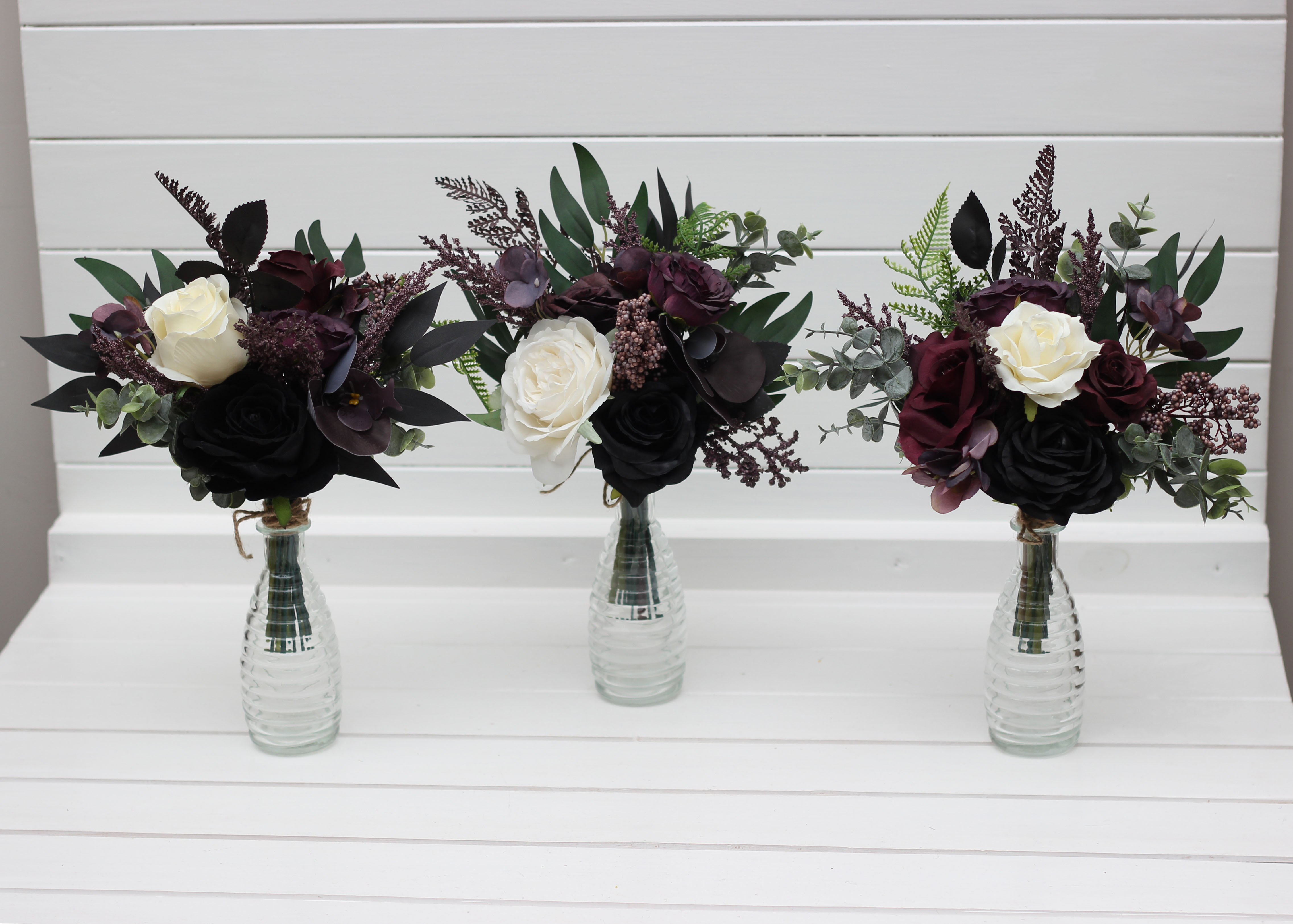 Deep purple black ivory and green floral arrangement