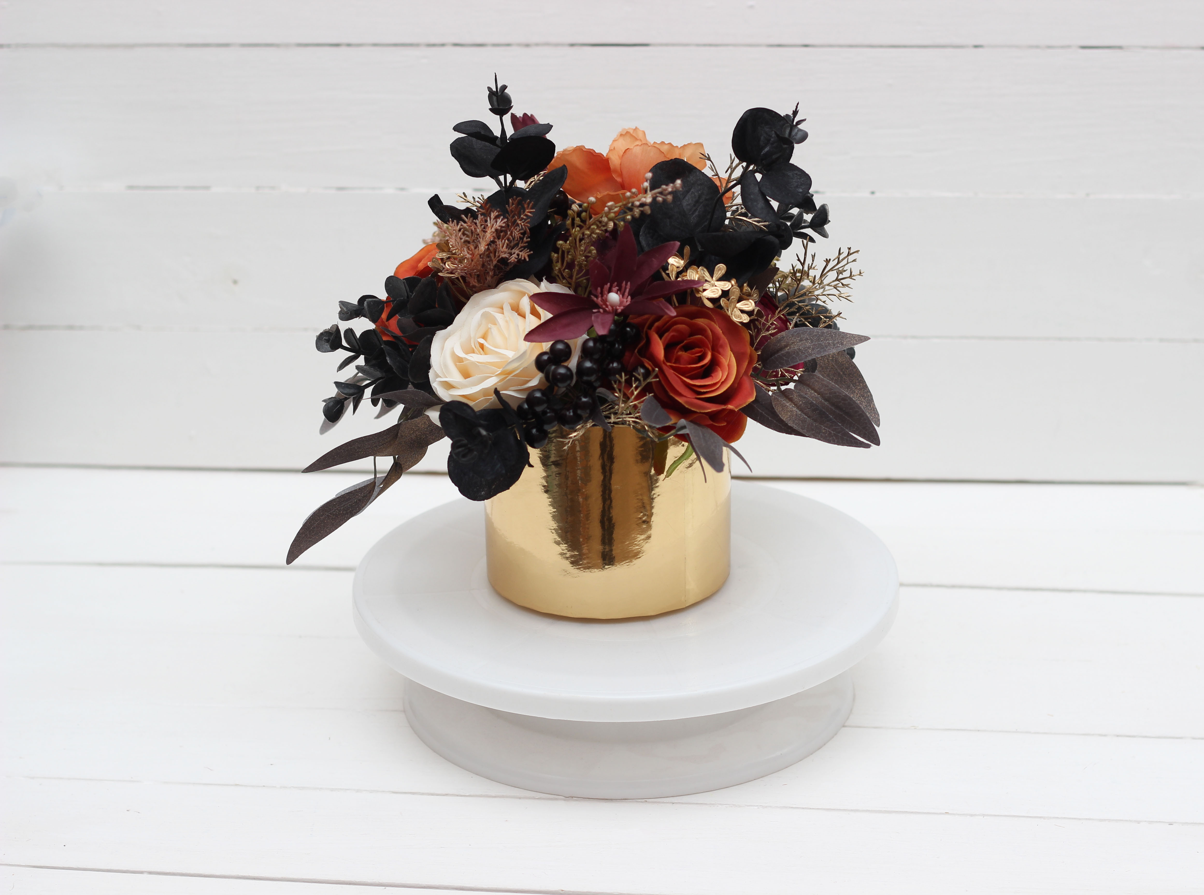 Purple black rust and gold floral arrangement
