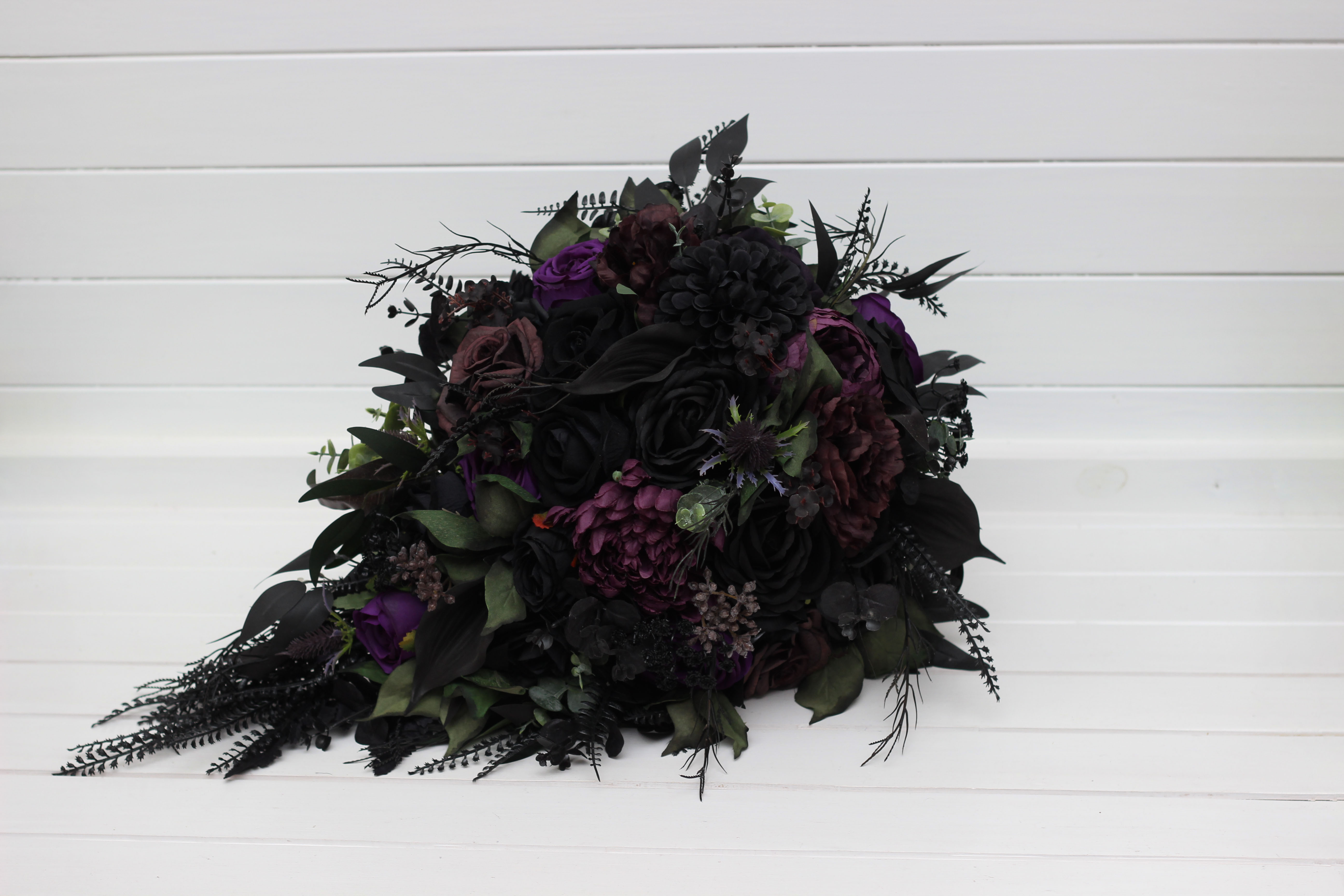 Deep purple royal purple black and green floral arrangement
