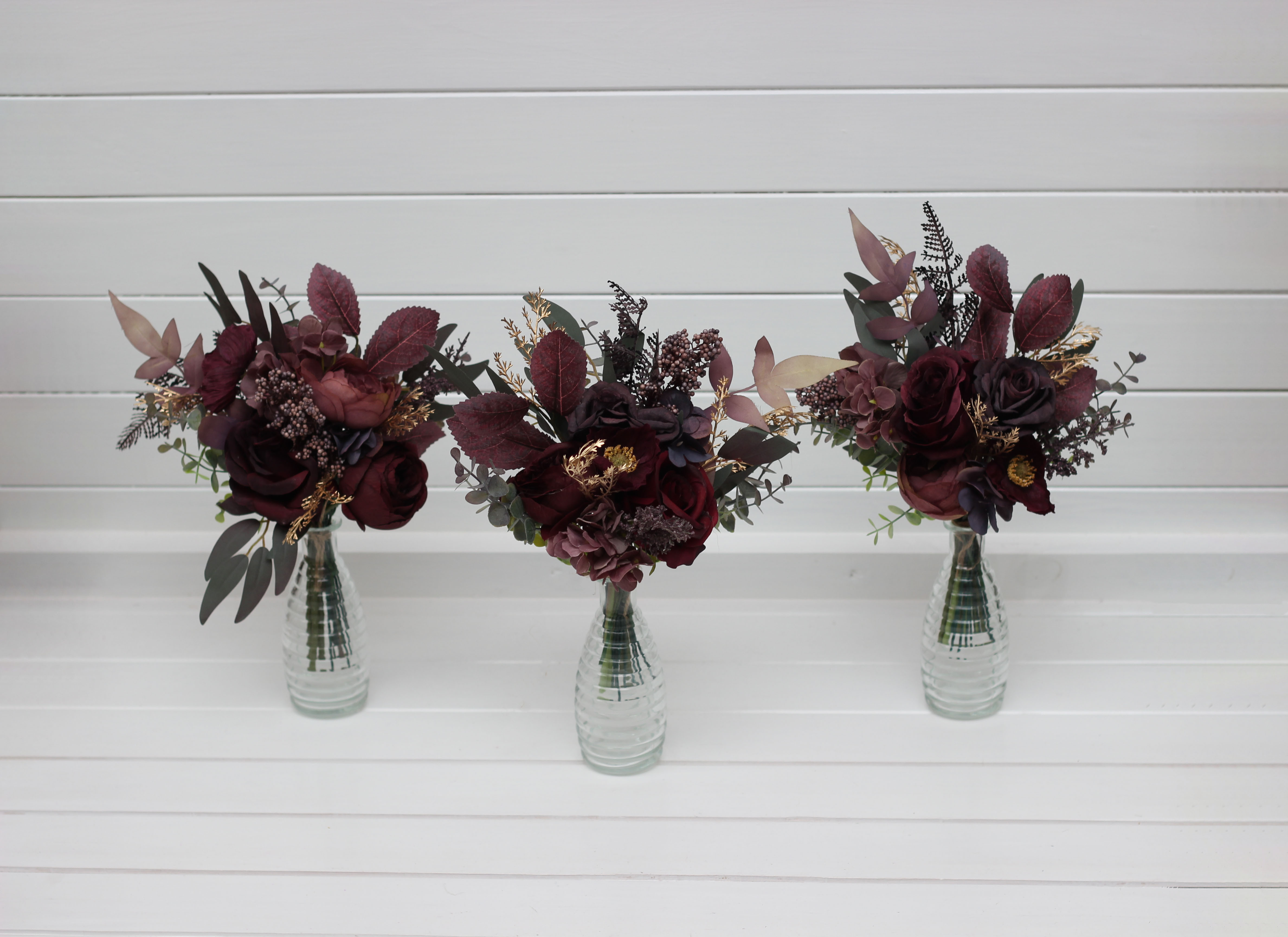 Deep purple burgundy and gold floral arrangement