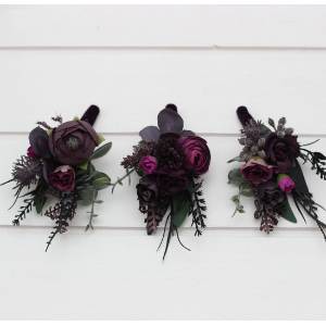 Wedding boutonnieres in a black, purple, and magenta colors. 5370